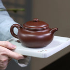 Broad 275 ml Fanggu teapot held in both hands