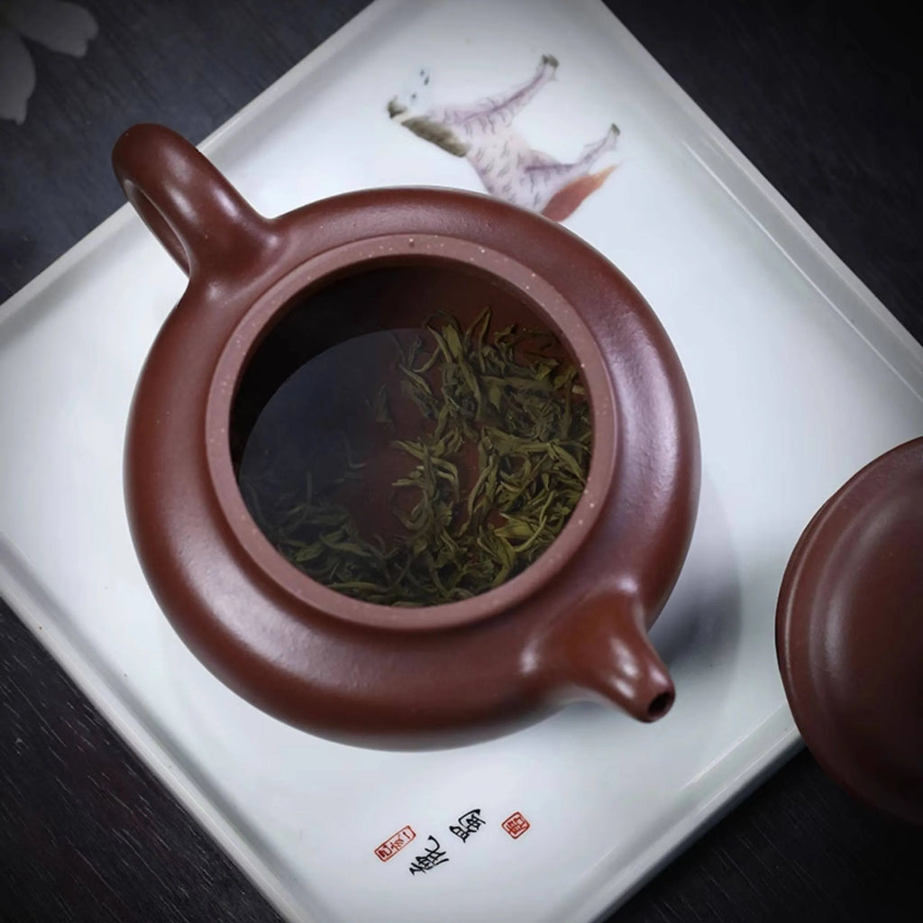 Interior of the Fanggu zini teapot with steeping leaves