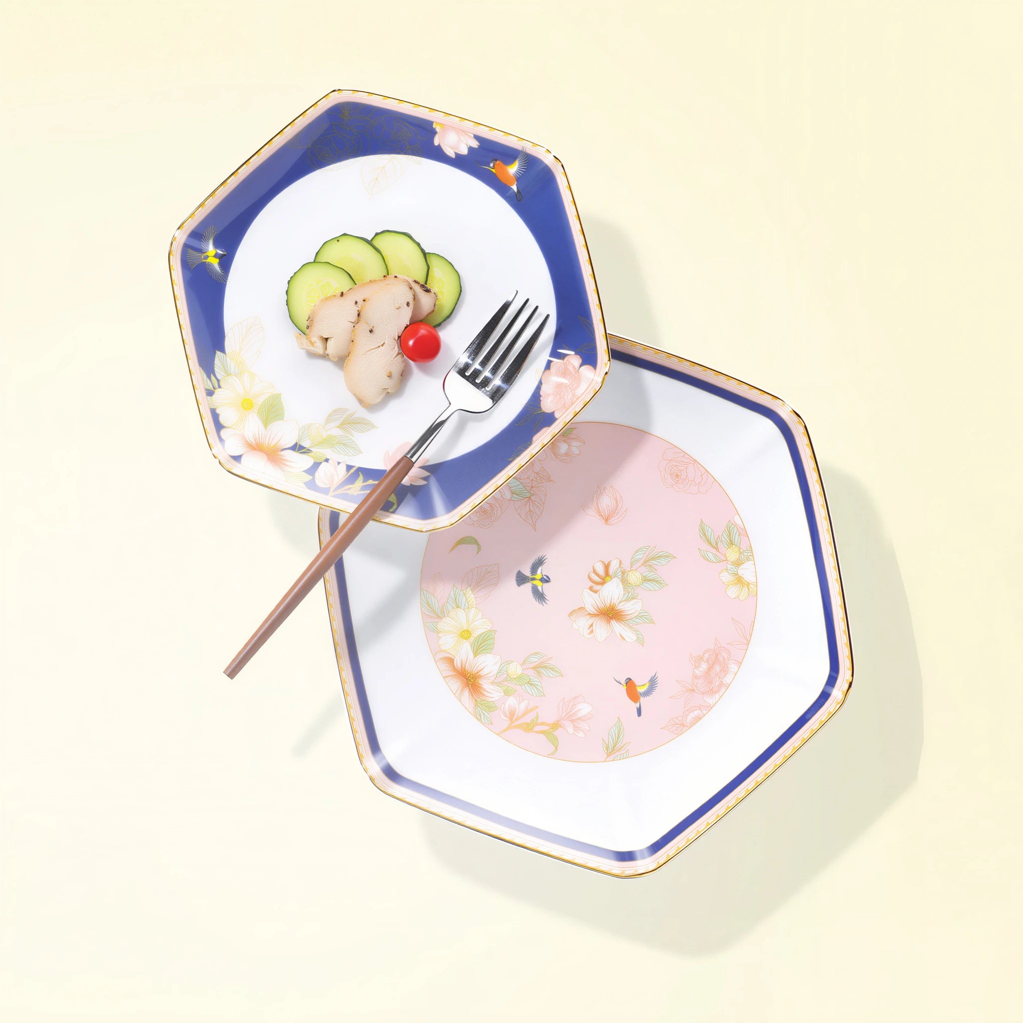 Two faceted Courtyard in Bloom porcelain plates styled with food, showing navy and blush floral fields.
