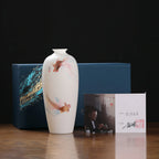 Goldfish Meiping vase beside its blue presentation box and accompanying product certificate
