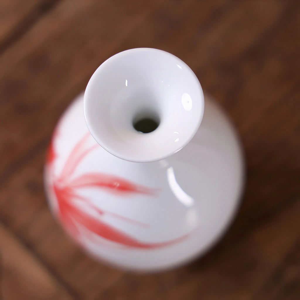 Close-up of the rounded mouth on a small white goldfish porcelain vase