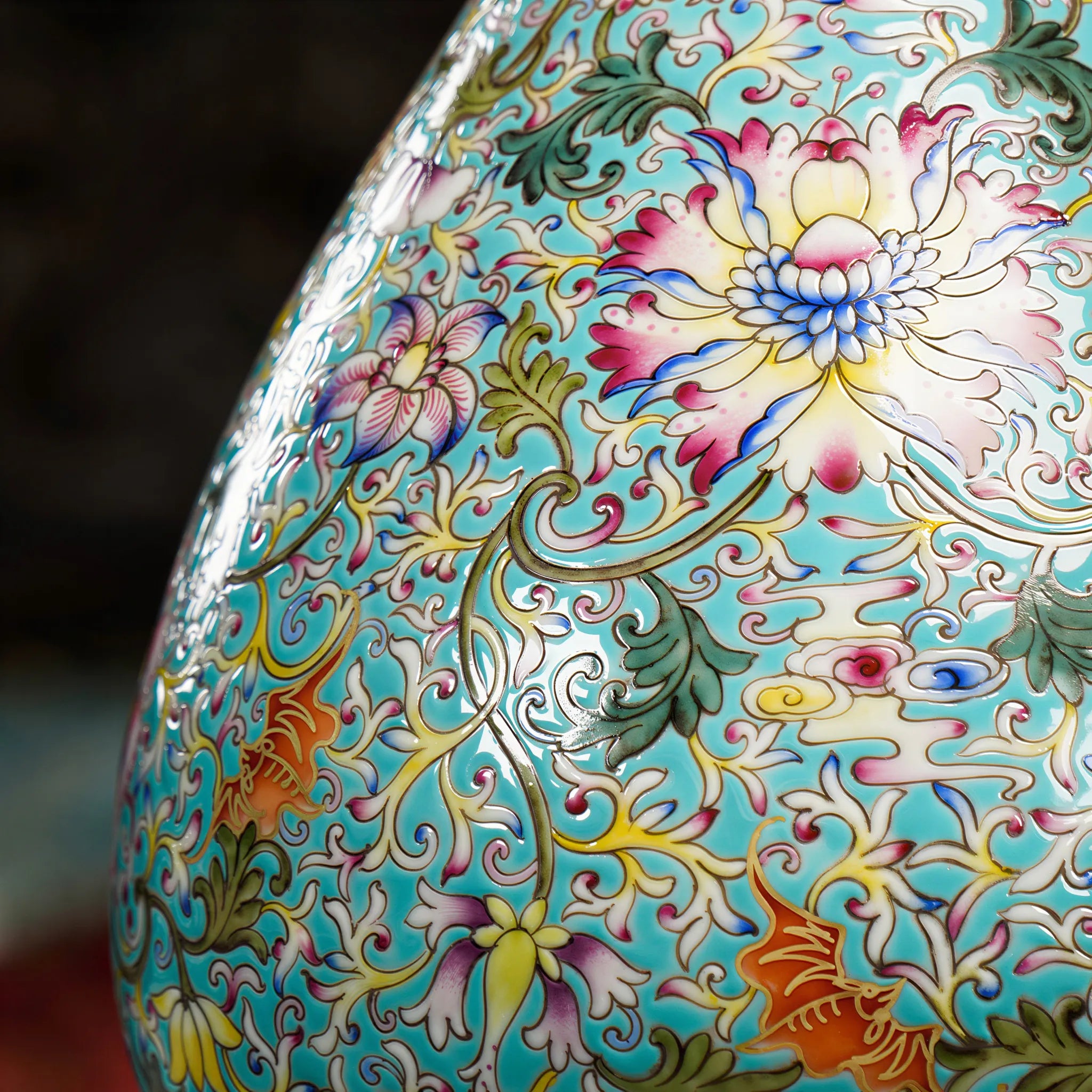 Red bat and floral enamel detail against the green ground