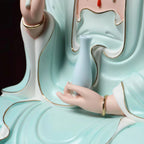 Detail of the vase held against the pale blue robe