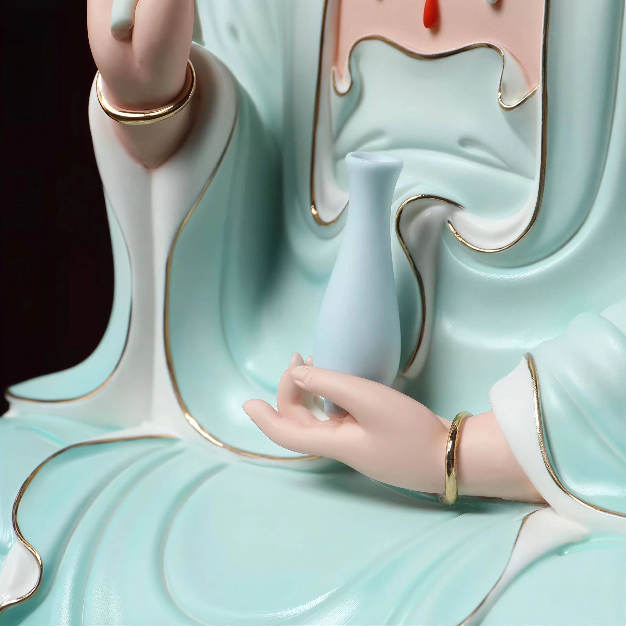 Detail of the vase held against the pale blue robe