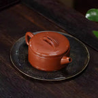 Low cylindrical Hanwa teapot arranged on a tea tray