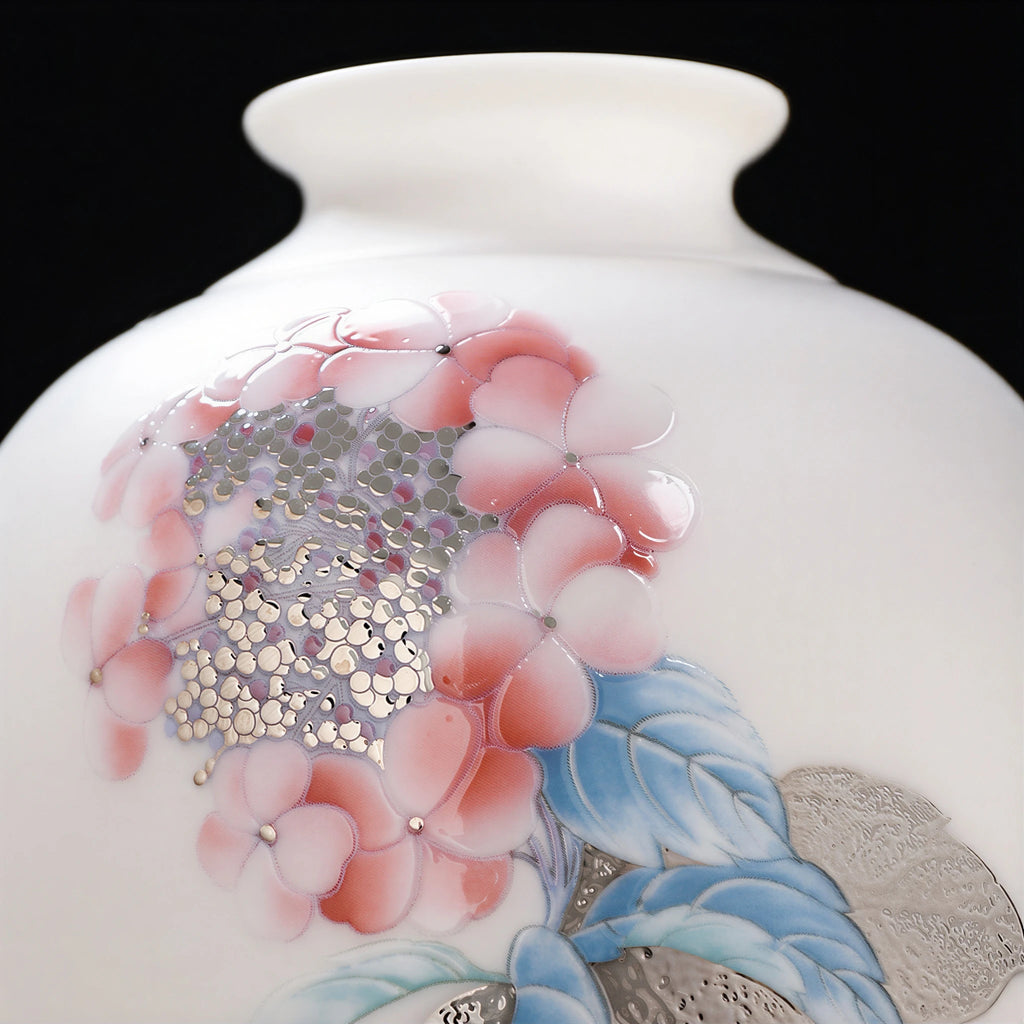 Close view of pink hydrangea petals with raised metallic-toned centers and blue leaves