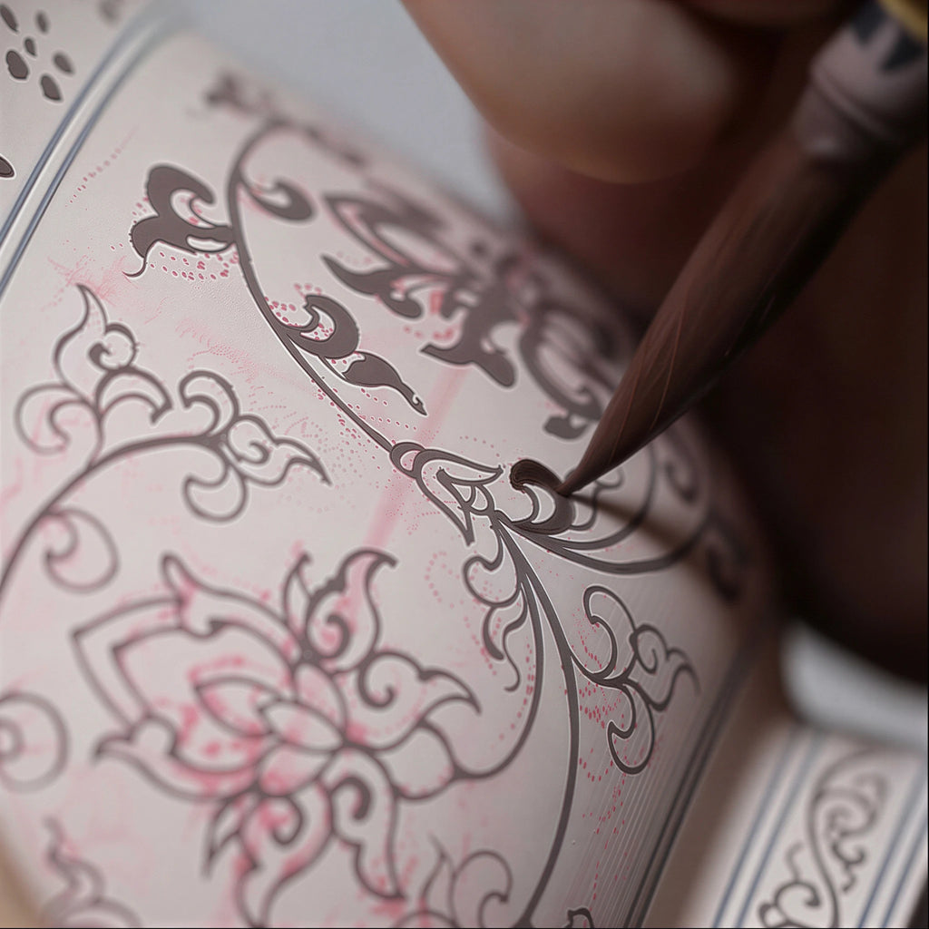Workshop view of the lotus design being painted on the cup