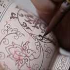 Workshop view of the lotus design being painted on the cup