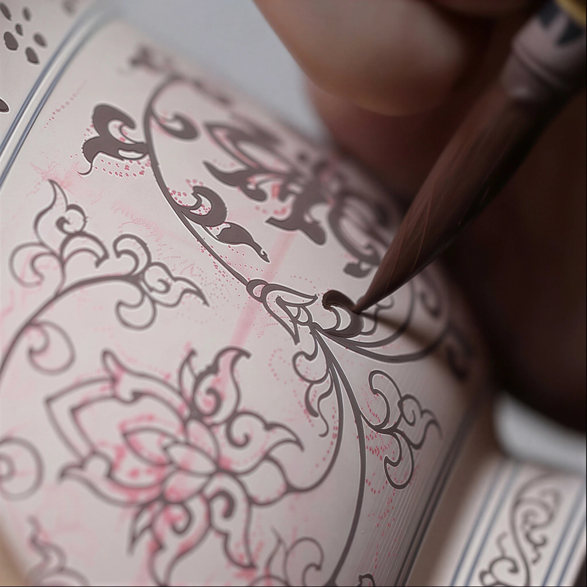 Workshop view of the lotus design being painted on the cup