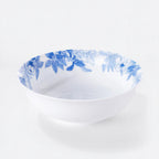 White porcelain serving bowl with a blue botanical border around the rim.