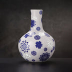 Front view of a Jingdezhen Tianqiu vase with cobalt floral medallions and white linglong windows