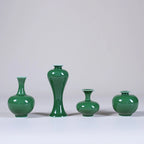 Four emerald-green Jingdezhen miniature porcelain vases on a pale studio background.