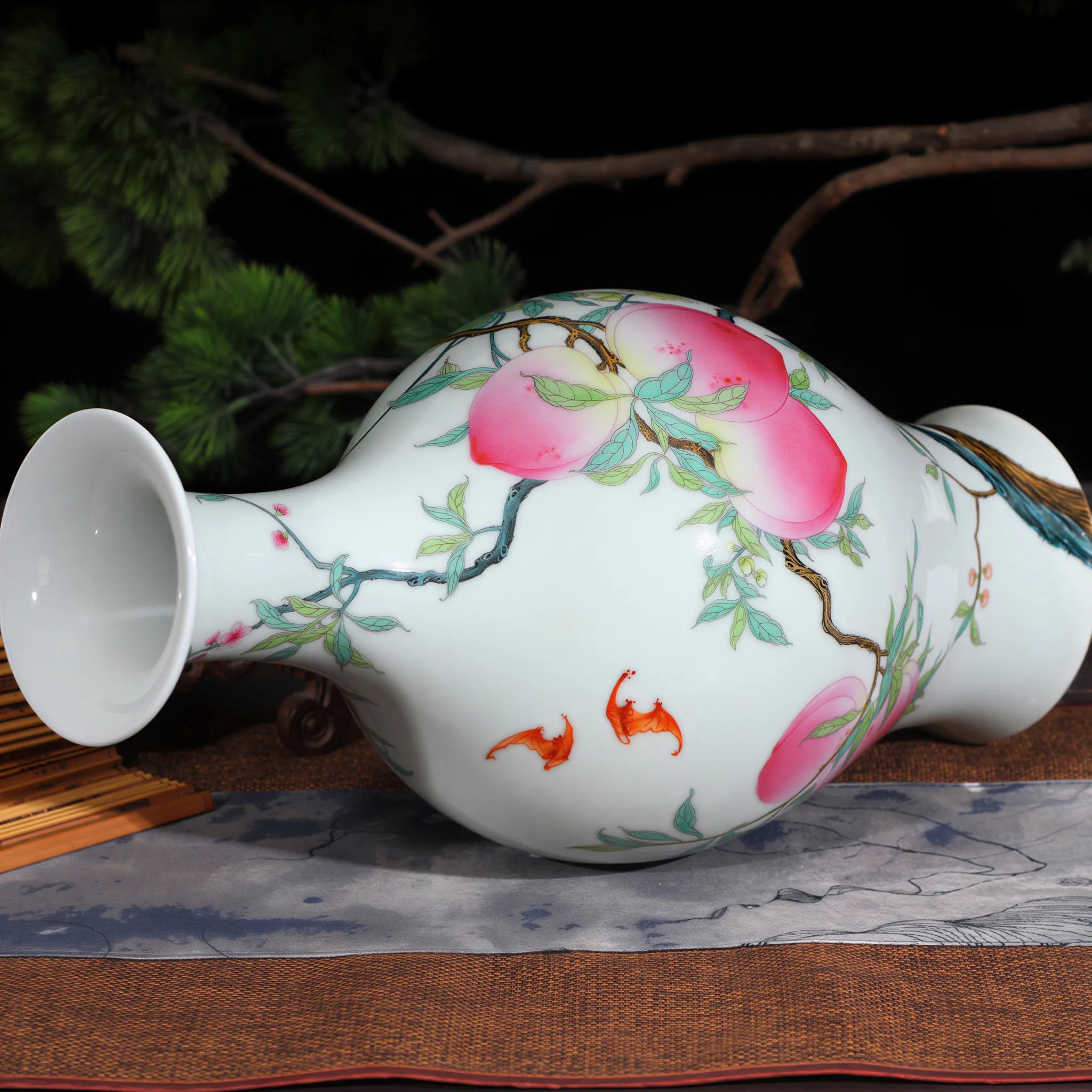 Side profile of the peach and bat olive-shaped vase