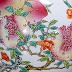 Close view of pink fruit, red pomegranate seeds, orange flowers and green leaves on the porcelain vase.