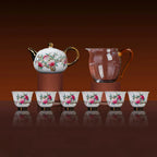 Eight-piece famille rose tea set with teapot, pitcher, and six cups