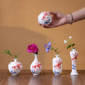 Jingdezhen hand-painted goldfish miniature porcelain vase set on a wooden table