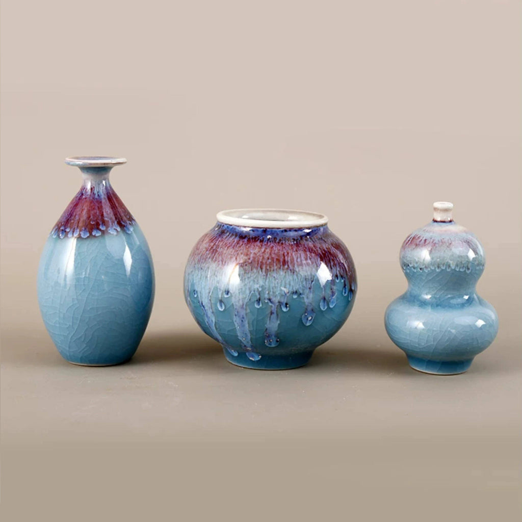 Trio of hand-thrown Jingdezhen porcelain vases showing blue and violet glaze variation