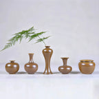 Five hand-thrown Jingdezhen maple-yellow mini porcelain vases arranged with a fern stem.
