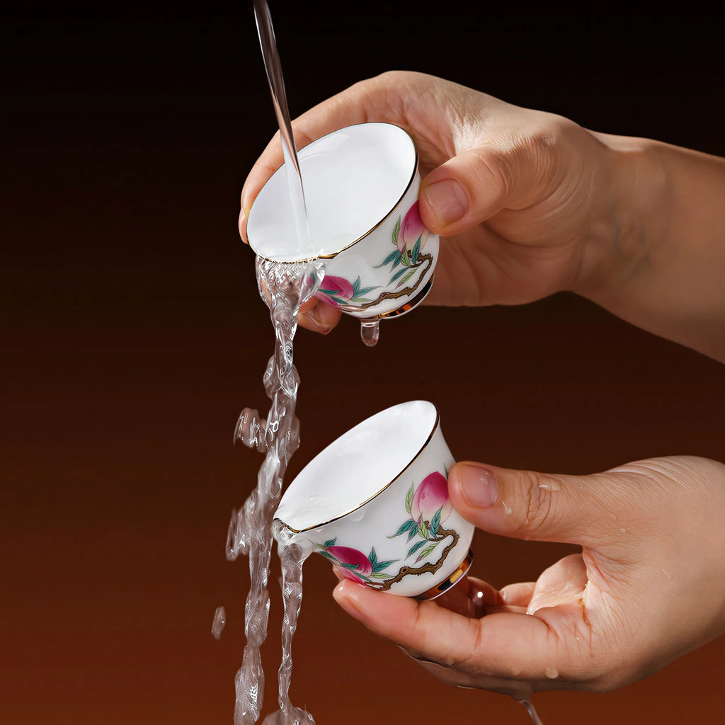 Water rinsing a Nine Peaches famille rose tasting cup