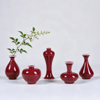 Five small oxblood red Jingdezhen mini porcelain vases arranged as a set
