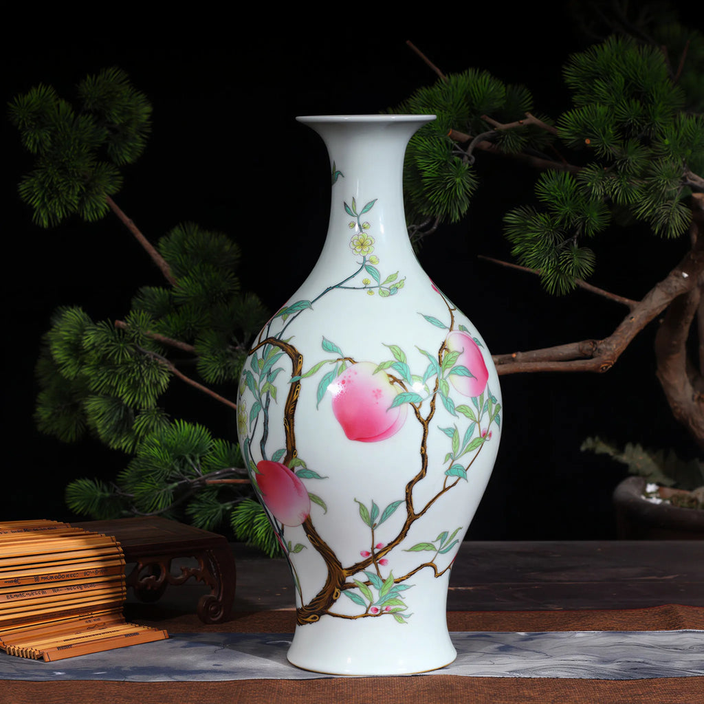 Famille rose peach and bat olive vase beside a bonsai