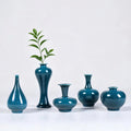 Five peacock green Jingdezhen mini porcelain vases arranged as a set