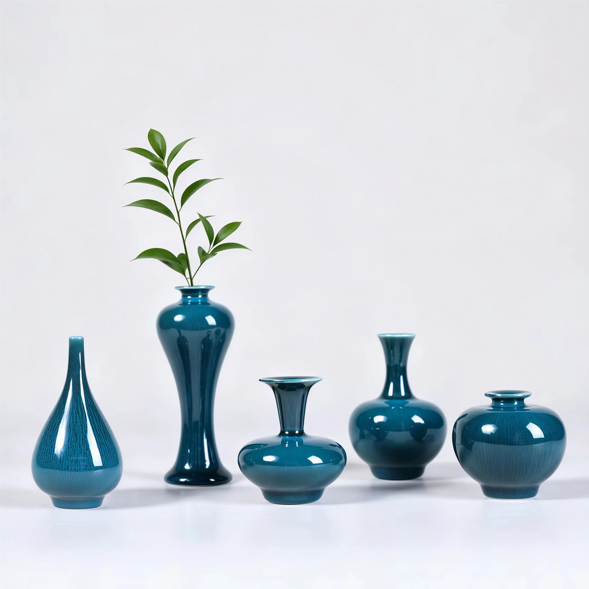 Five peacock green Jingdezhen mini porcelain vases arranged as a set