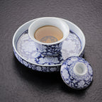 Peony gaiwan placed on the ceramic tea stage