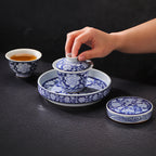 Hands arranging the in-glaze peony gongfu tea set
