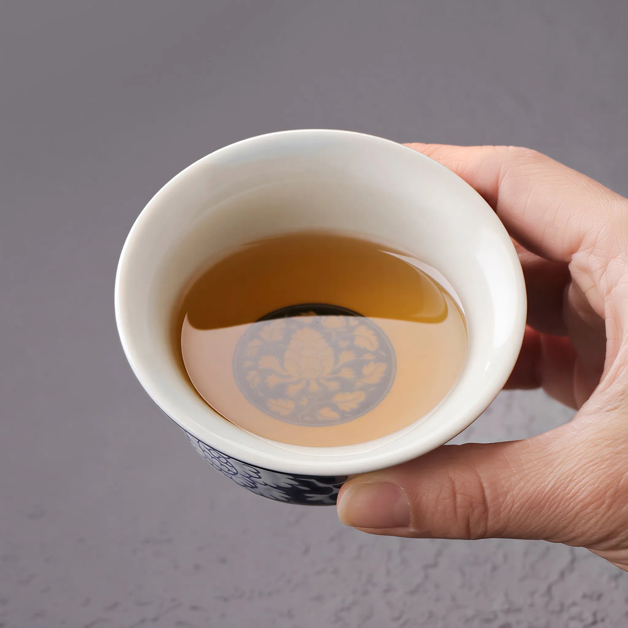 Wide press-hand master cup with in-glaze peony decoration