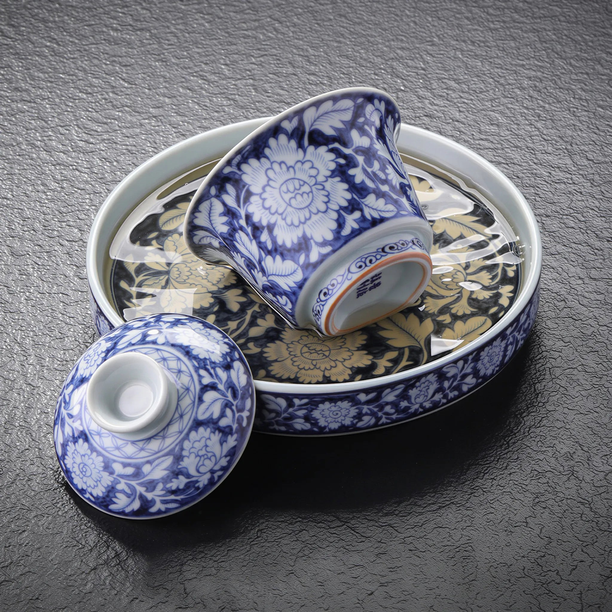 Ceramic tea stage catching water during gongfu brewing