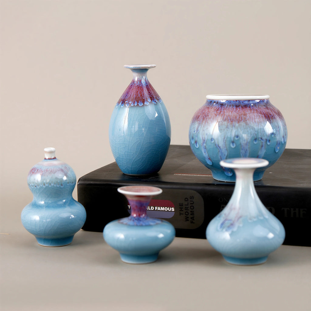 Jingdezhen miniature porcelain vase set with blue reactive glaze on a black book