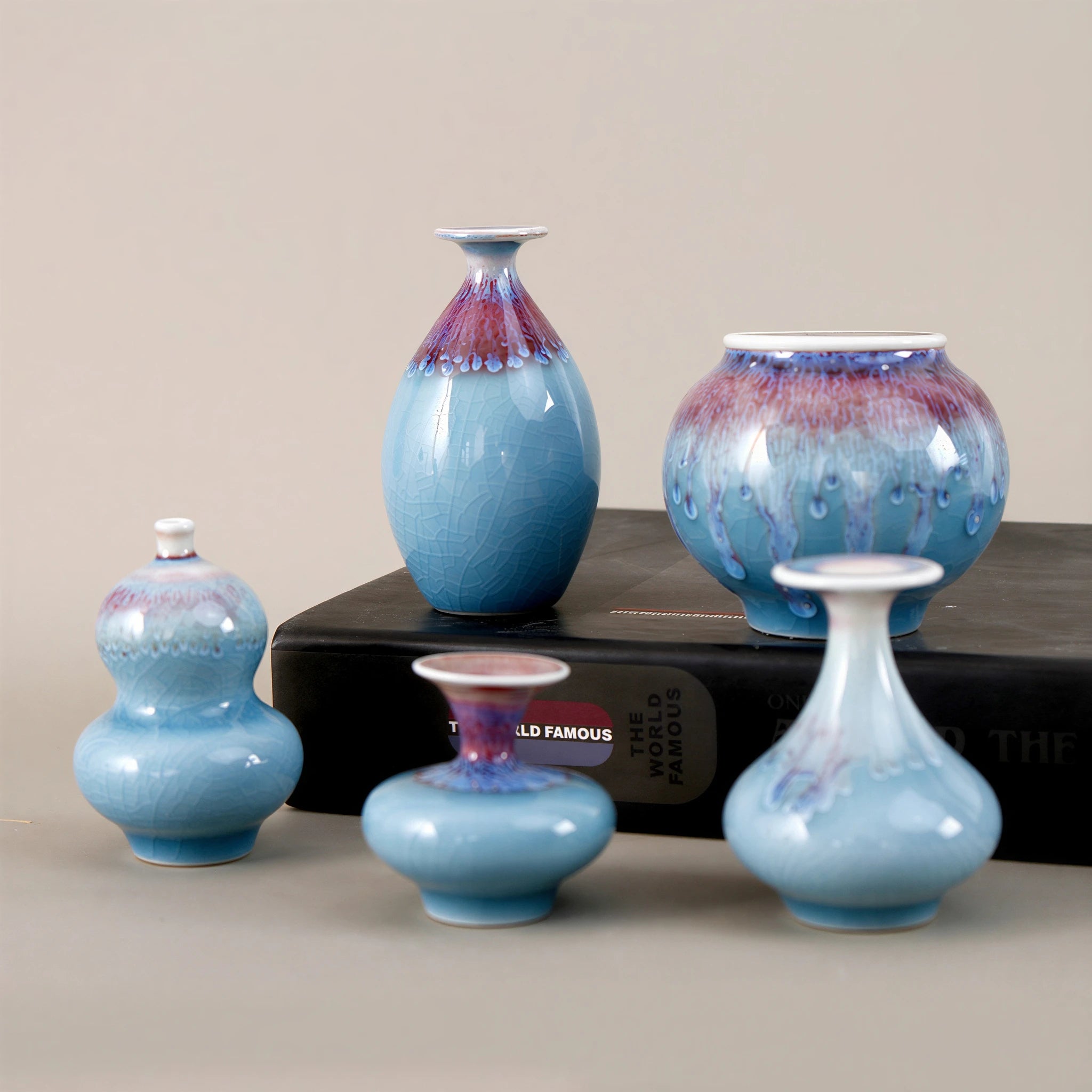 Jingdezhen miniature porcelain vase set with blue reactive glaze on a black book