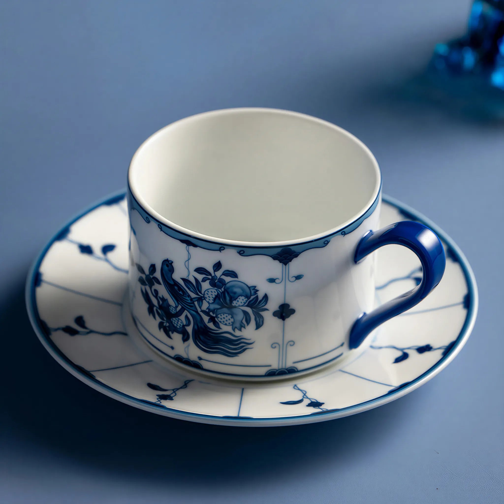 Jingdezhen ribbon bird porcelain coffee cup held in hand