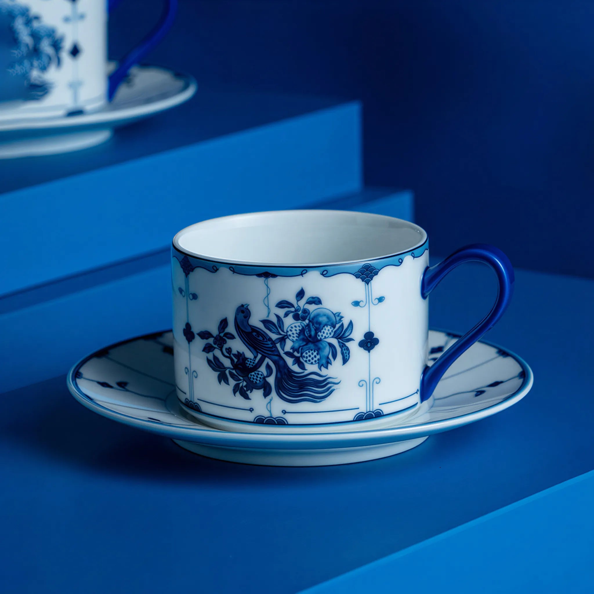Flared porcelain coffee cup with cobalt ribbon bird motif