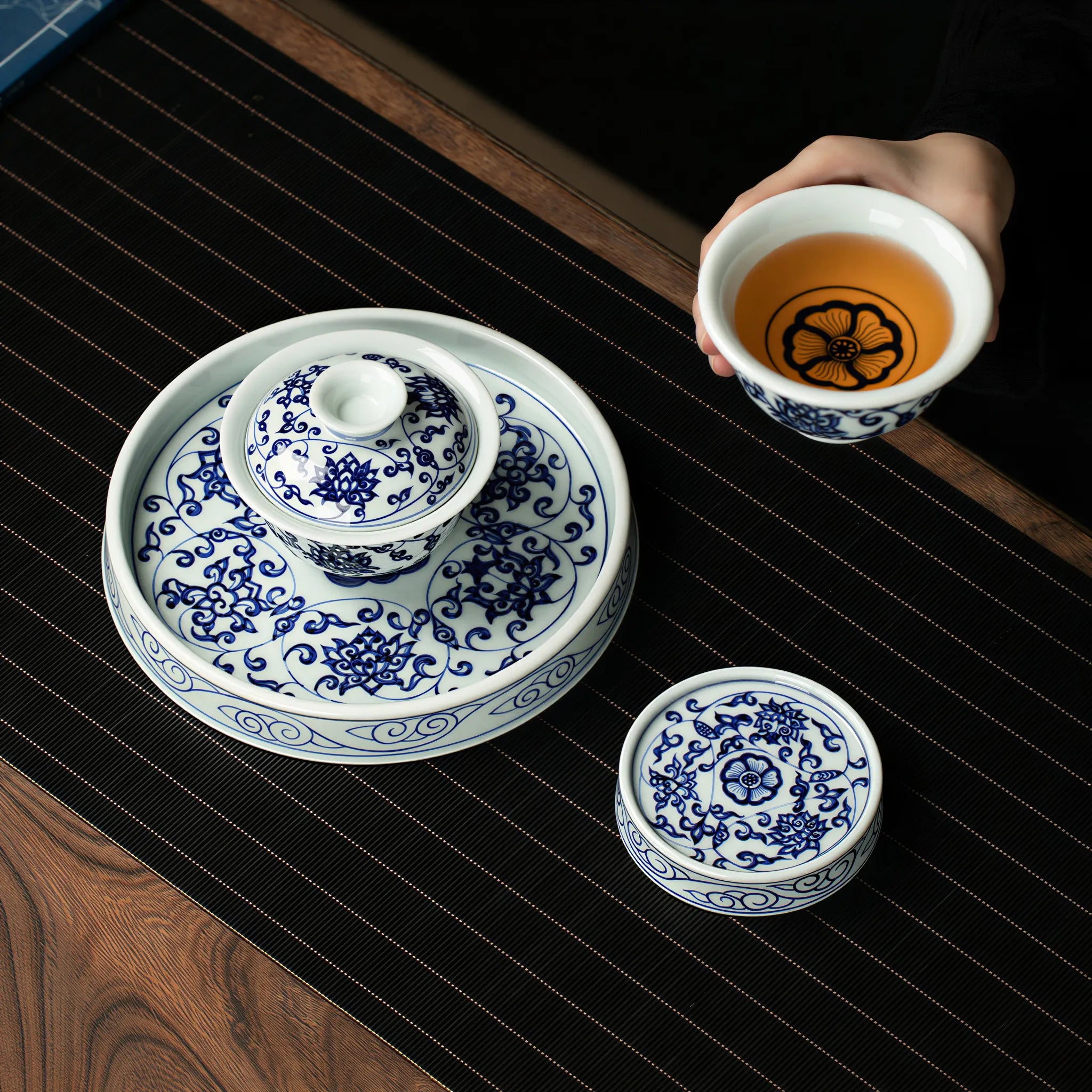 Overhead view of the gaiwan, cup, tea stage, and lid rest