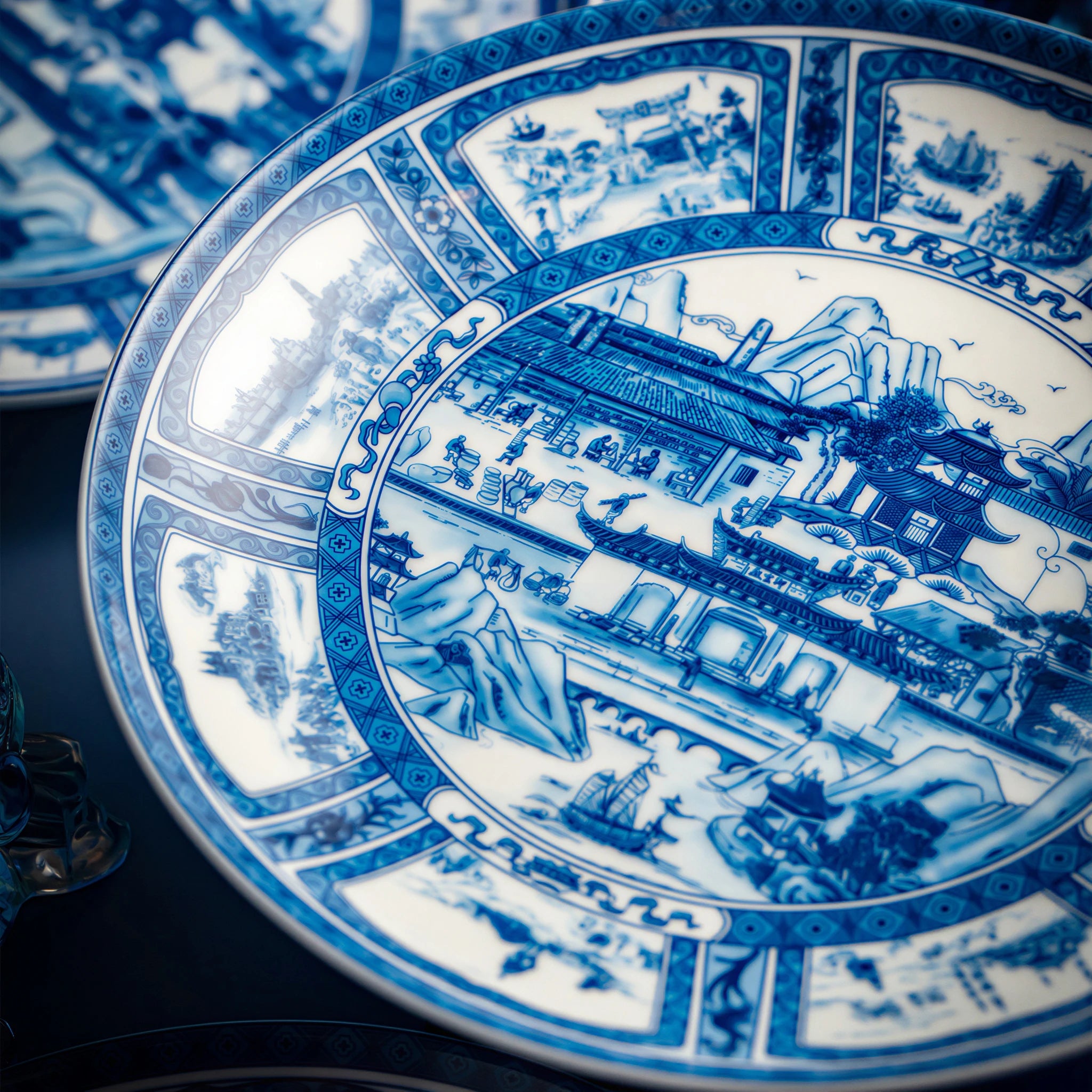 Close view of the central blue pictorial scene on the Jingdezhen Silk Road porcelain plate.