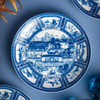 Overhead view of the Jingdezhen Silk Road in-glaze porcelain plate with segmented blue border panels.