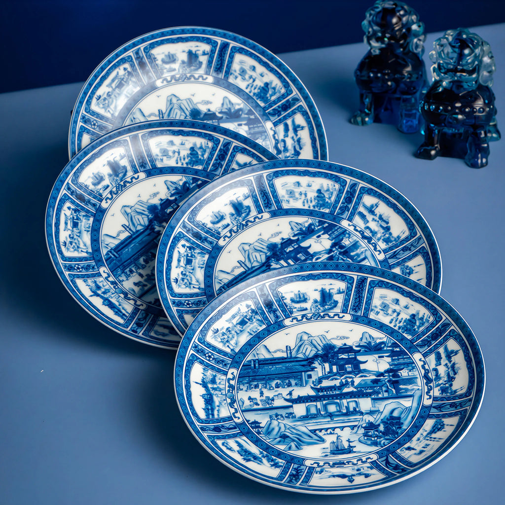 Overlapping Silk Road porcelain plates arranged in a blue cabinet-style display.