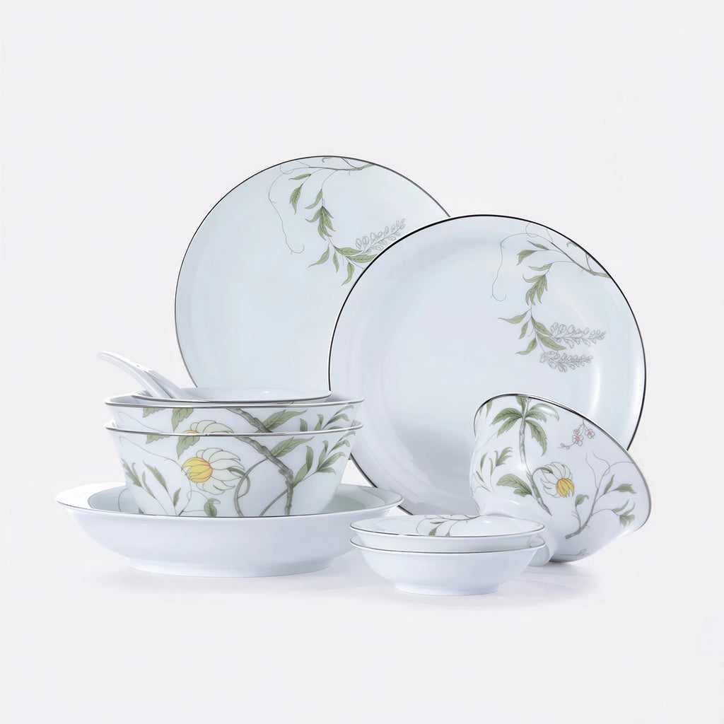 Complete Spring Dawn eleven-piece Jingdezhen porcelain dinnerware set with green botanical decoration and silver-colored rims on a white background.