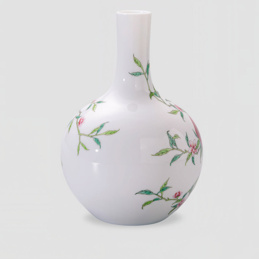 Back of the white porcelain Tianqiu vase with scattered leafy branches and pink blossoms.