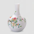 Side view of the Tianqiu vase with pale pink fruit, green leaves and fine branches on white porcelain.