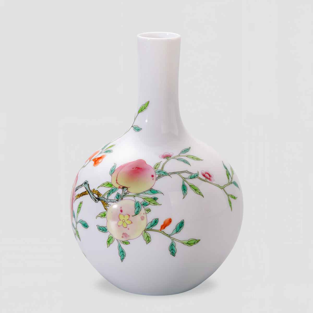 Side view of the Tianqiu vase with pale pink fruit, green leaves and fine branches on white porcelain.