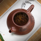 Open zini Shipiao teapot with steeping tea leaves