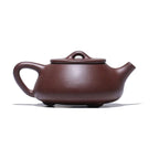 Angled profile of the carved landscape Shipiao teapot