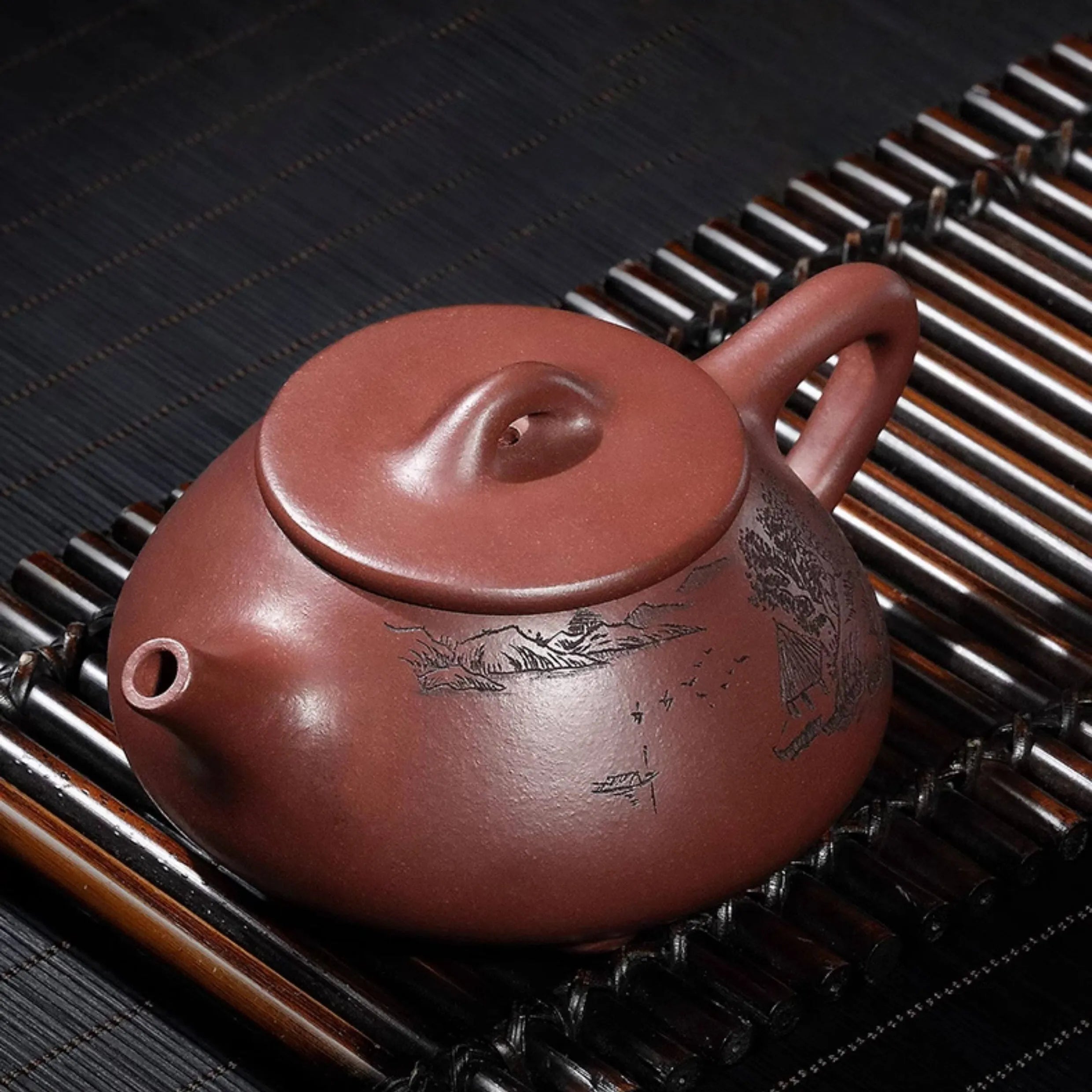 Landscape Shipiao teapot in use on a bamboo tea mat