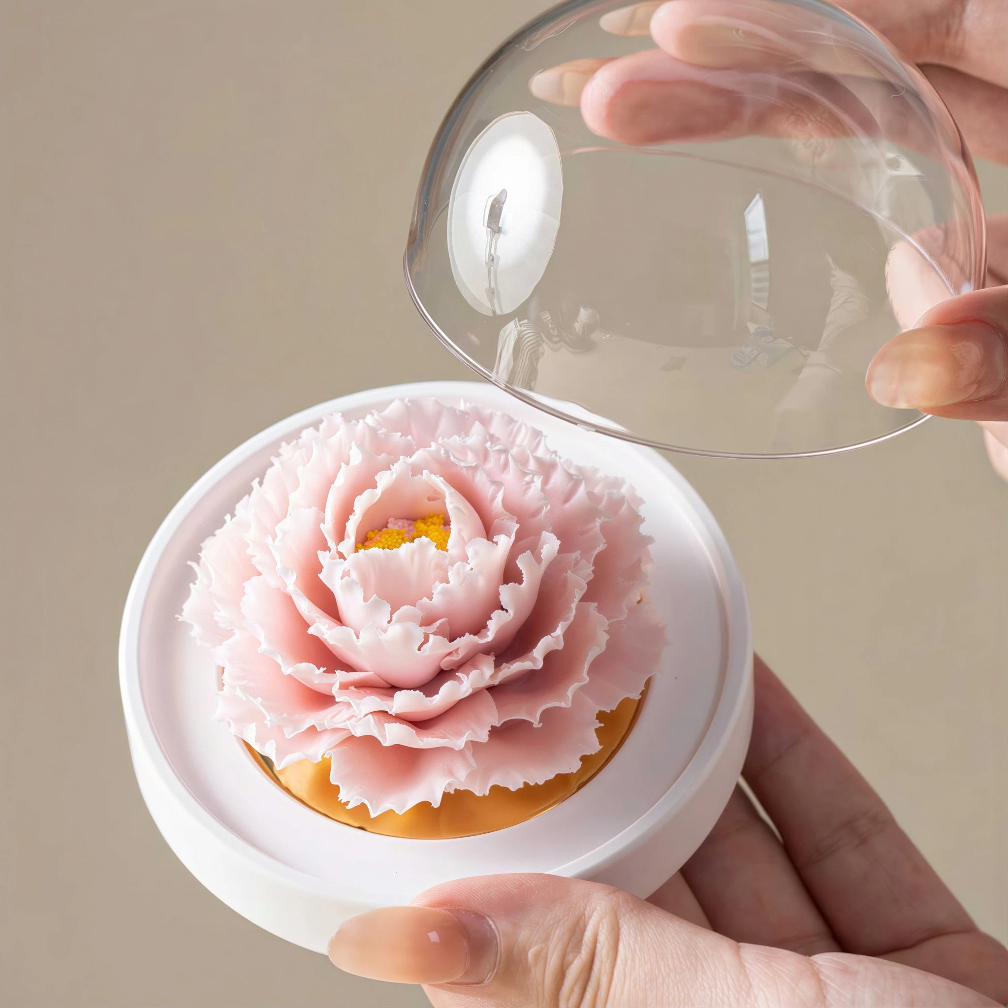 Clear dome being lifted from the pink porcelain carnation