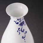 Close view of the flared mouth, cobalt neck scroll and white porcelain shoulder