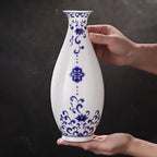 Jingdezhen linglong Guanyin vase held between two hands to show its 26 cm scale