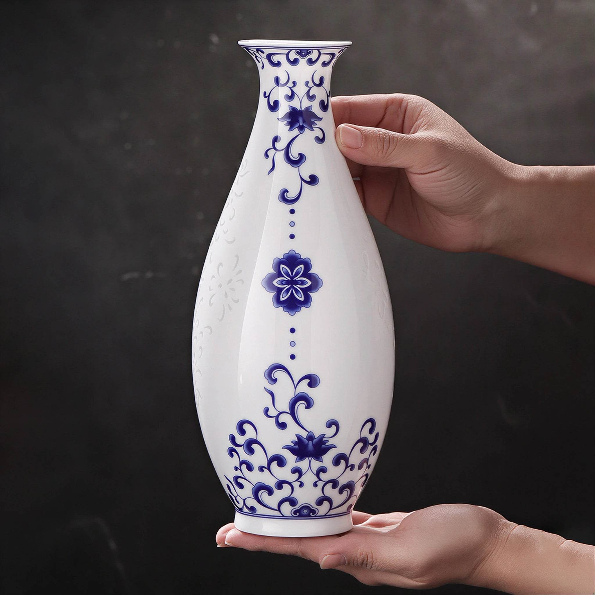 Jingdezhen linglong Guanyin vase held between two hands to show its 26 cm scale